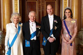 LONDON, ENGLAND - DECEMBER 05: (EDITORIAL USE ONLY) (L-R) Queen Camilla, King Charles III, Prince William, Prince of Wales and Catherine, Princess of Wales pose for a photograph ahead of The Diplomatic Reception in the 1844 Room at Buckingham Palace on December 05, 2023 in London, England. 