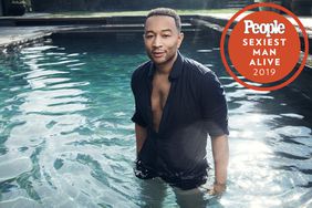 John legend standing in a pool in a button down shirt
