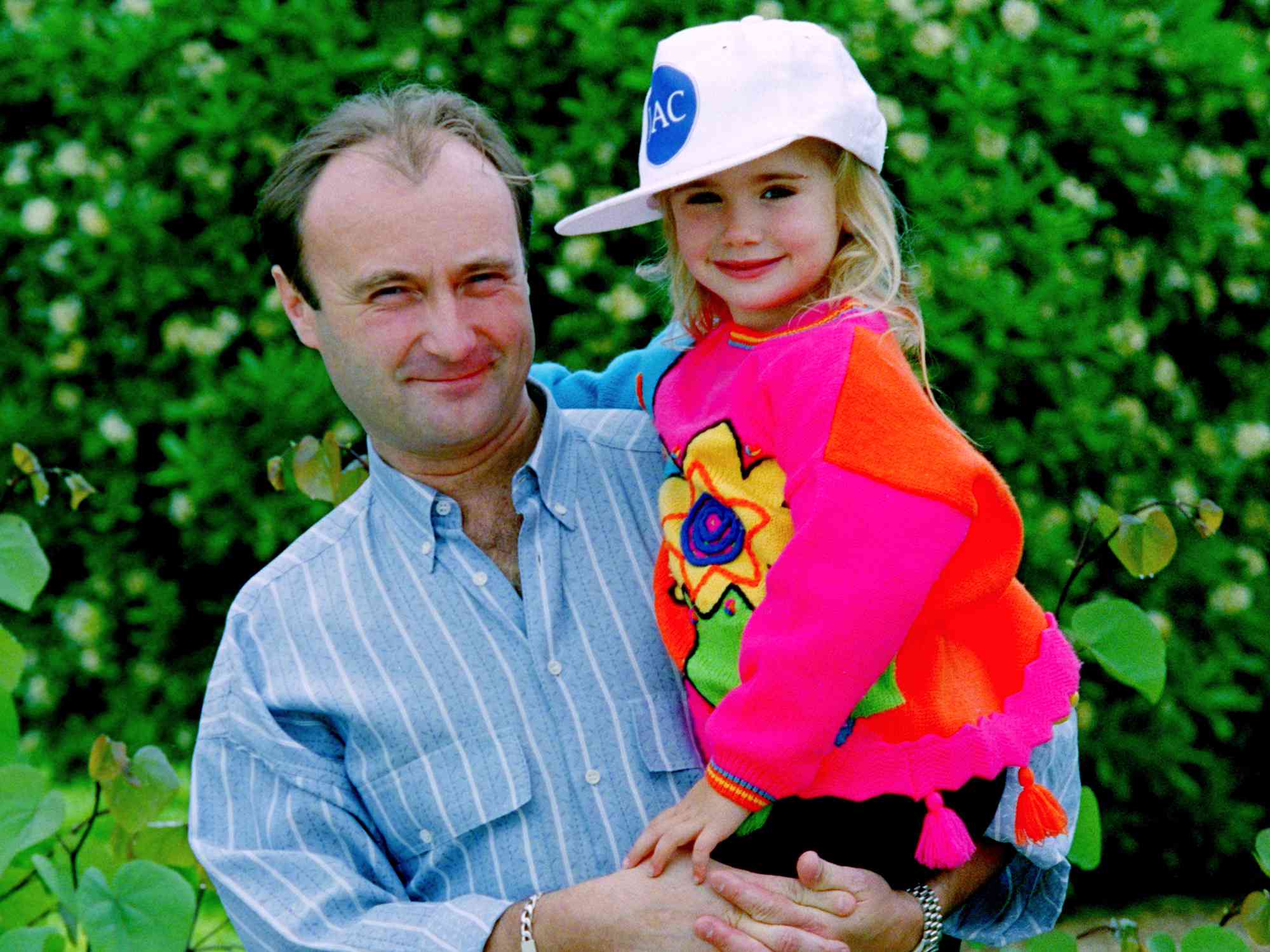 Phil Collins (L) with daughter Lily Collins