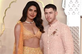 Priyanka Chopra Jonas (L) and her husband American singer-songwriter and actor Nick Jonas (R) pose for photos as they arrive to attend the wedding ceremony of billionaire tycoon and Chairman of Reliance Industries Mukesh Ambani's son Anant Ambani and Radhika Merchant in Mumbai o