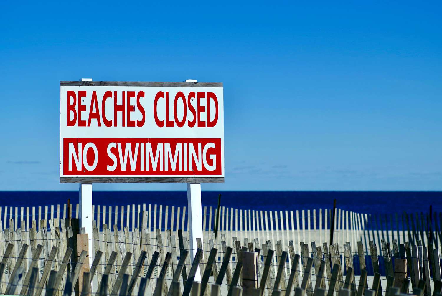 Large closed sign on the beach