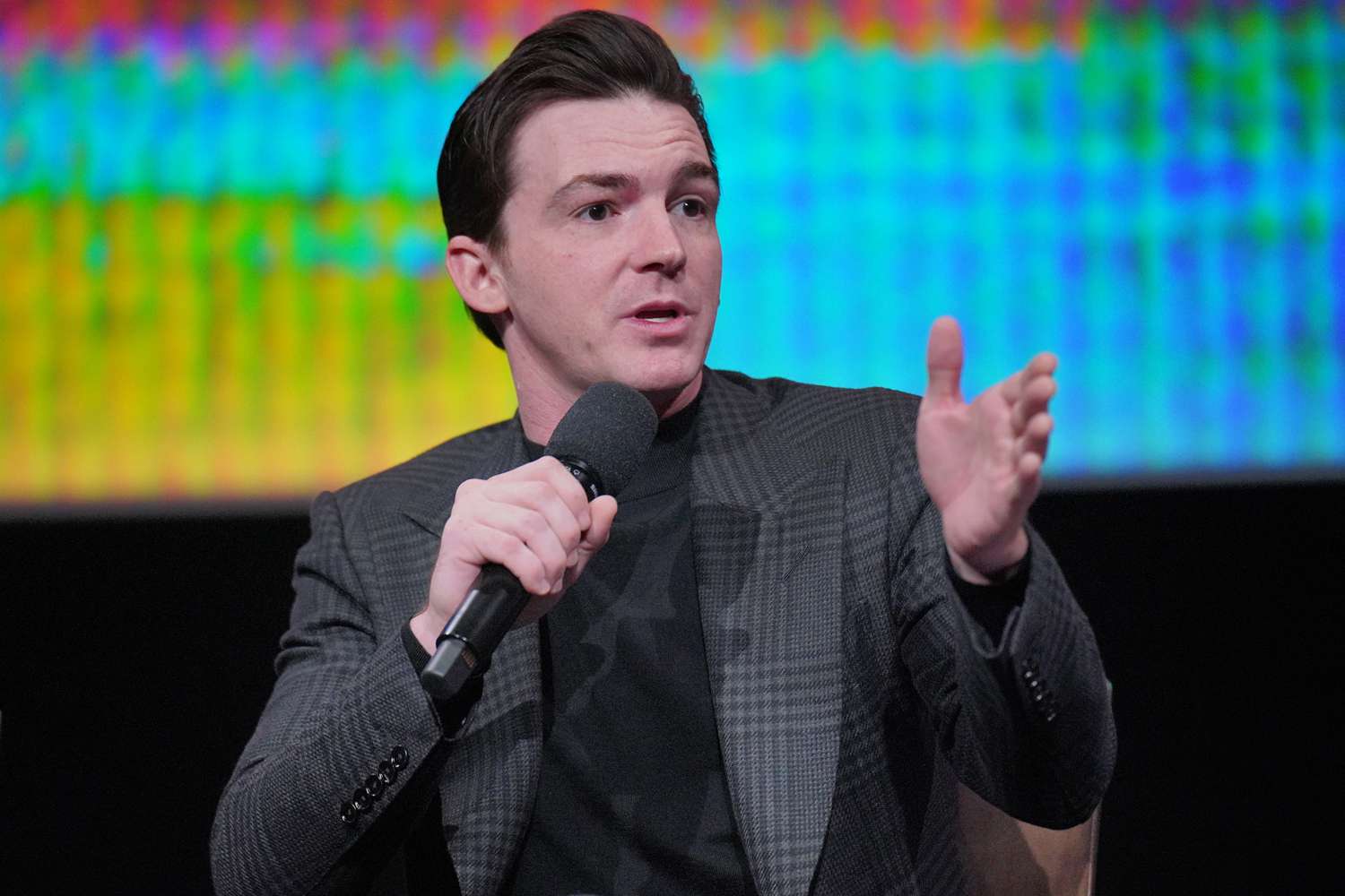 Drake Bell speaks onstage during the "Quiet On Set: The Dark Side of Kids TV" For Your 