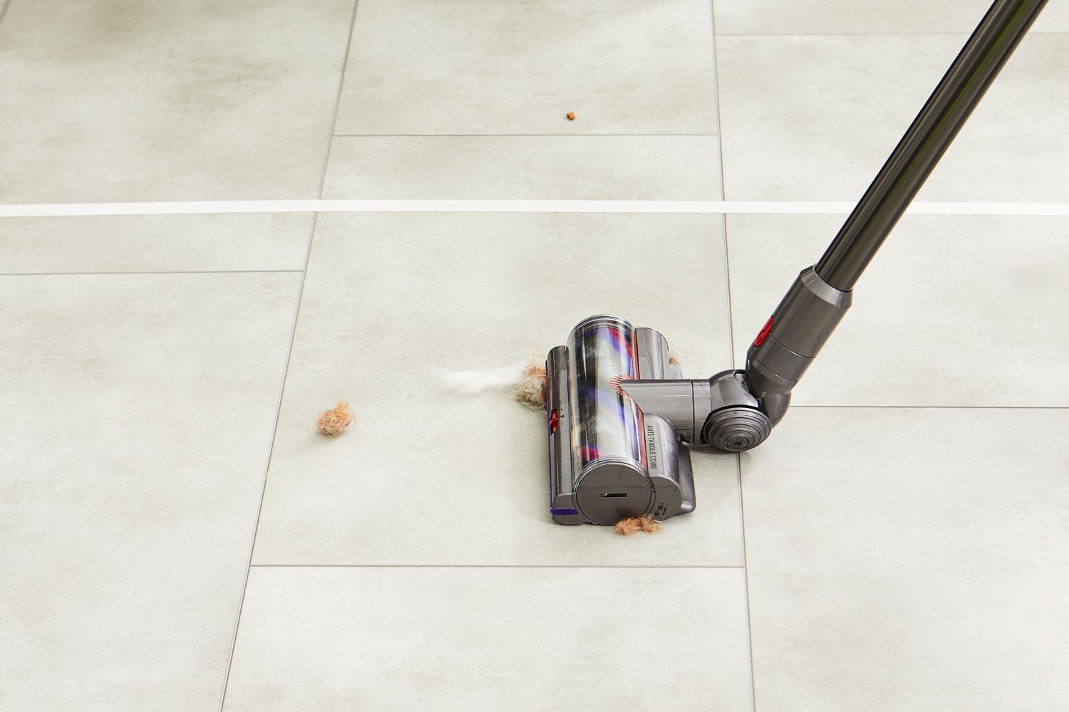 Dyson V15 Detect Cordless Vacuum Cleaner cleaning fur from the tile floor