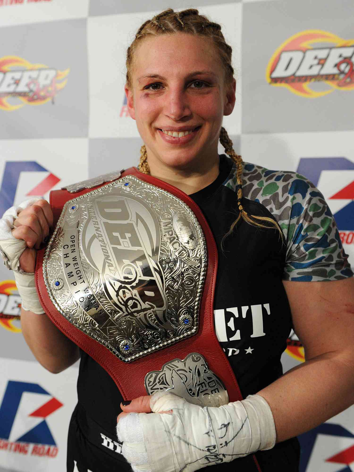 Amanda Lucas poses with the belt in her post match media conference after the DEEP57 fight against Yumiko Hotta on February 18, 2012 in Tokyo, Japan. 