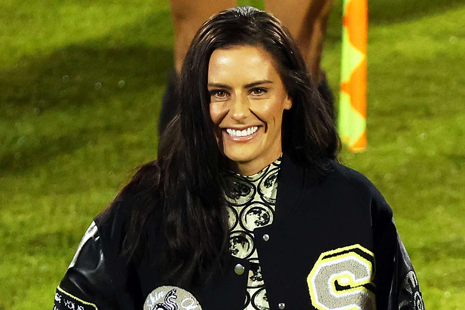 Ali Krieger poses next to a framed jersey celebrating her career and retirement at Toyota Stadium on December 5, 2023 in Frisco, Texas.