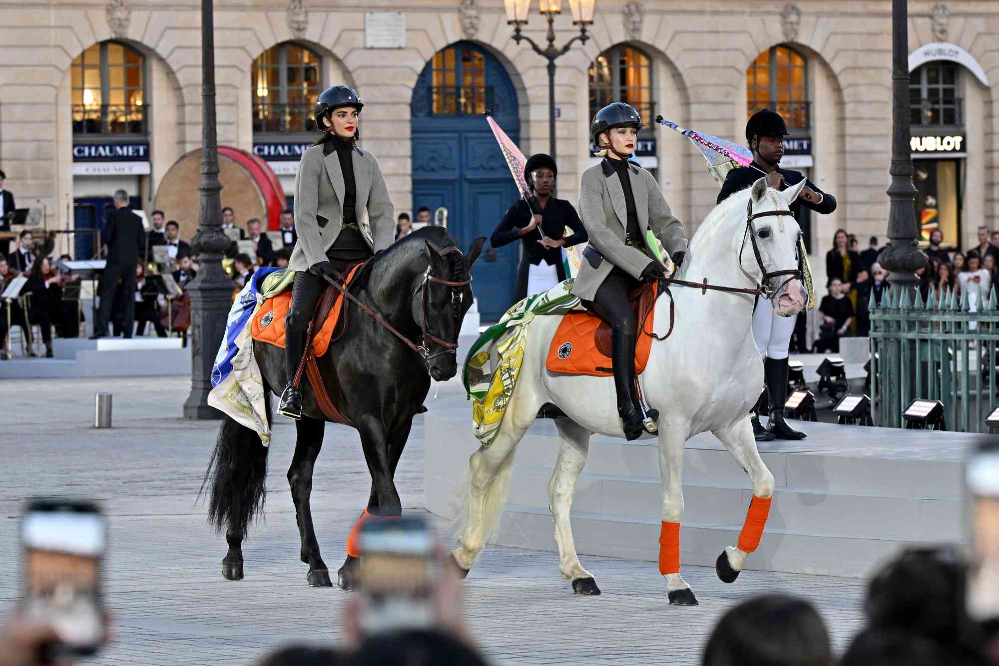 Kendall Jenner and Gigi Hadid ride horses on the runway during Vogue World: Paris at Place Vendome on June 23, 2024 in Paris, France.
