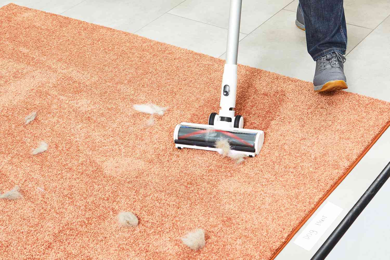 Tineco Pure One S11 Smart Stick/Handheld Vacuum sweeping up pet fur on a orange carpet