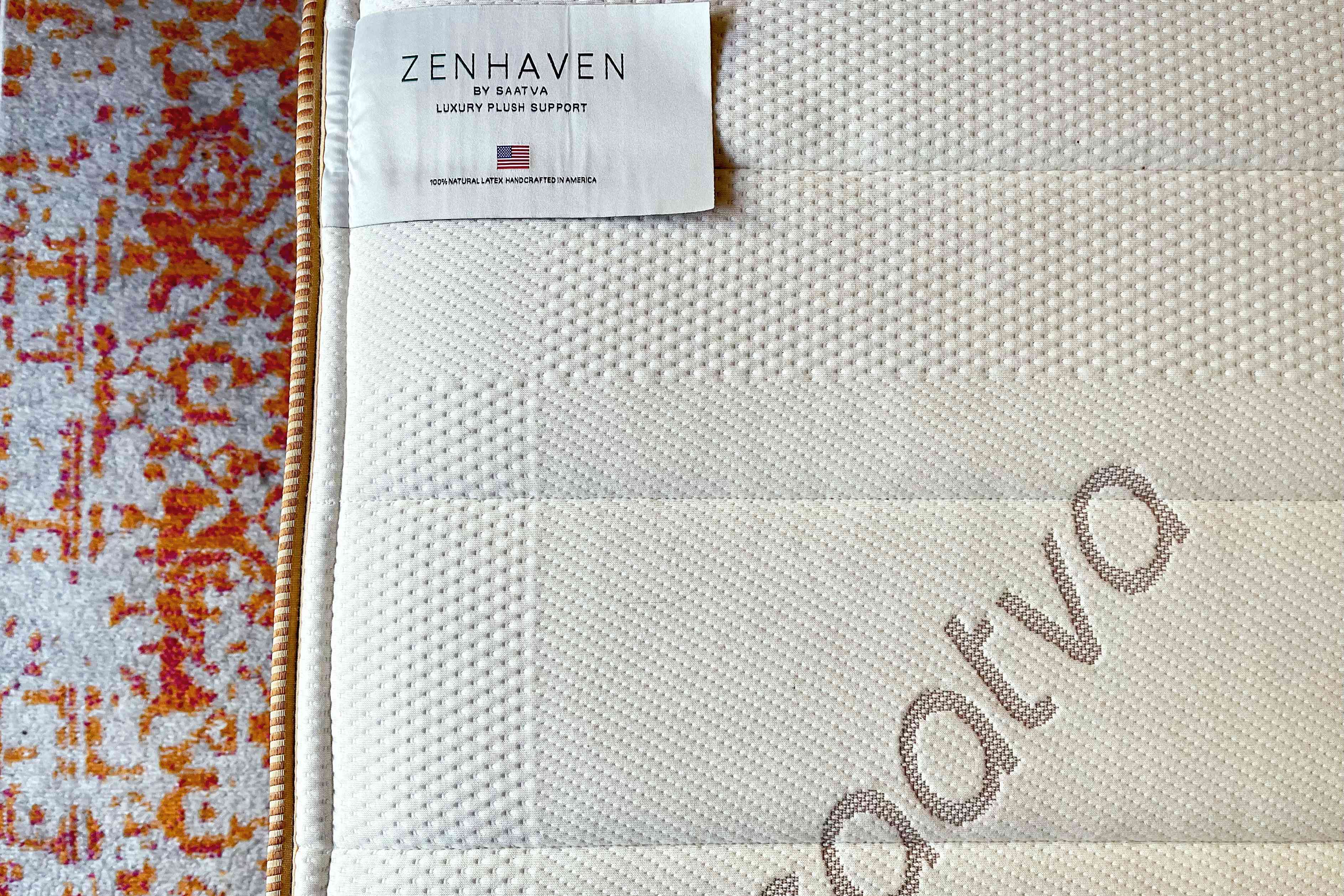 Closeup of Saatva Zenhaven Natural Latex Mattress label while displayed on rug