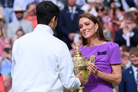 Catherine Princess of Wales presents the winner's trophy to Spain's Carlos Alcaraz after beating Serbia's Novak Djokovic during their men's singles final tennis match on day fourteen of the Wimbledon Tennis Championships at the All England Lawn Tennis and Croquet Club on July 14, 2024 in London, England. 