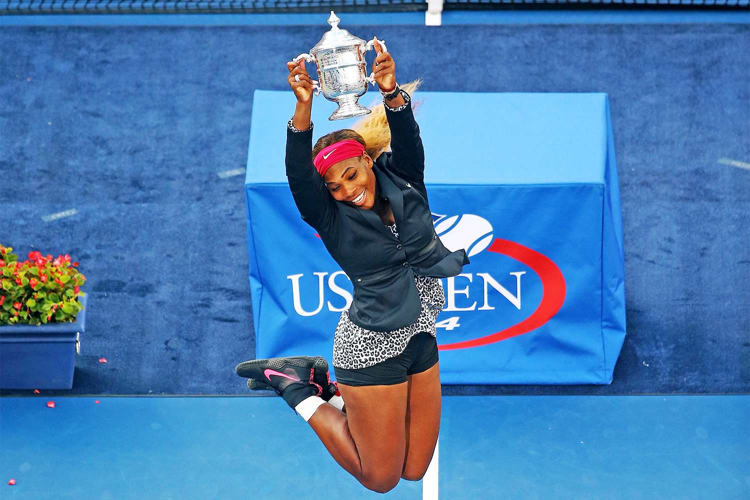 NEW YORK, NY - SEPTEMBER 07: Serena Williams of the United States celebrates with the trophy after defeating Caroline Wozniacki of Denmark to win their women's singles final match on Day fourteen of the 2014 US Open at the USTA Billie Jean King National Tennis Center on September 7, 2014 in the Flushing neighborhood of the Queens borough of New York City. Williams defeated Wozniacki in two sets by a score of 6-3, 6-3. (Photo by Streeter Lecka/Getty Images)