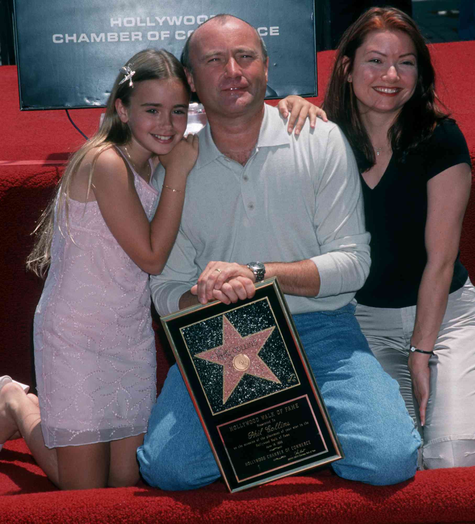 Phil Collins and daughters Lily Collins and Joely Collins attend Phil Collins Receives Walk of Fame Star on June 16, 1999