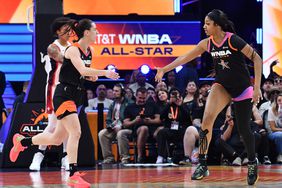 Caitlin Clark 22 and Angel Reese 5 of Team WNBA high five during the game against the USA Basketball Women's National Team during the 2024 WNBA All Star Game on July 20, 2024 at Footprint Center in Phoenix, Arizona