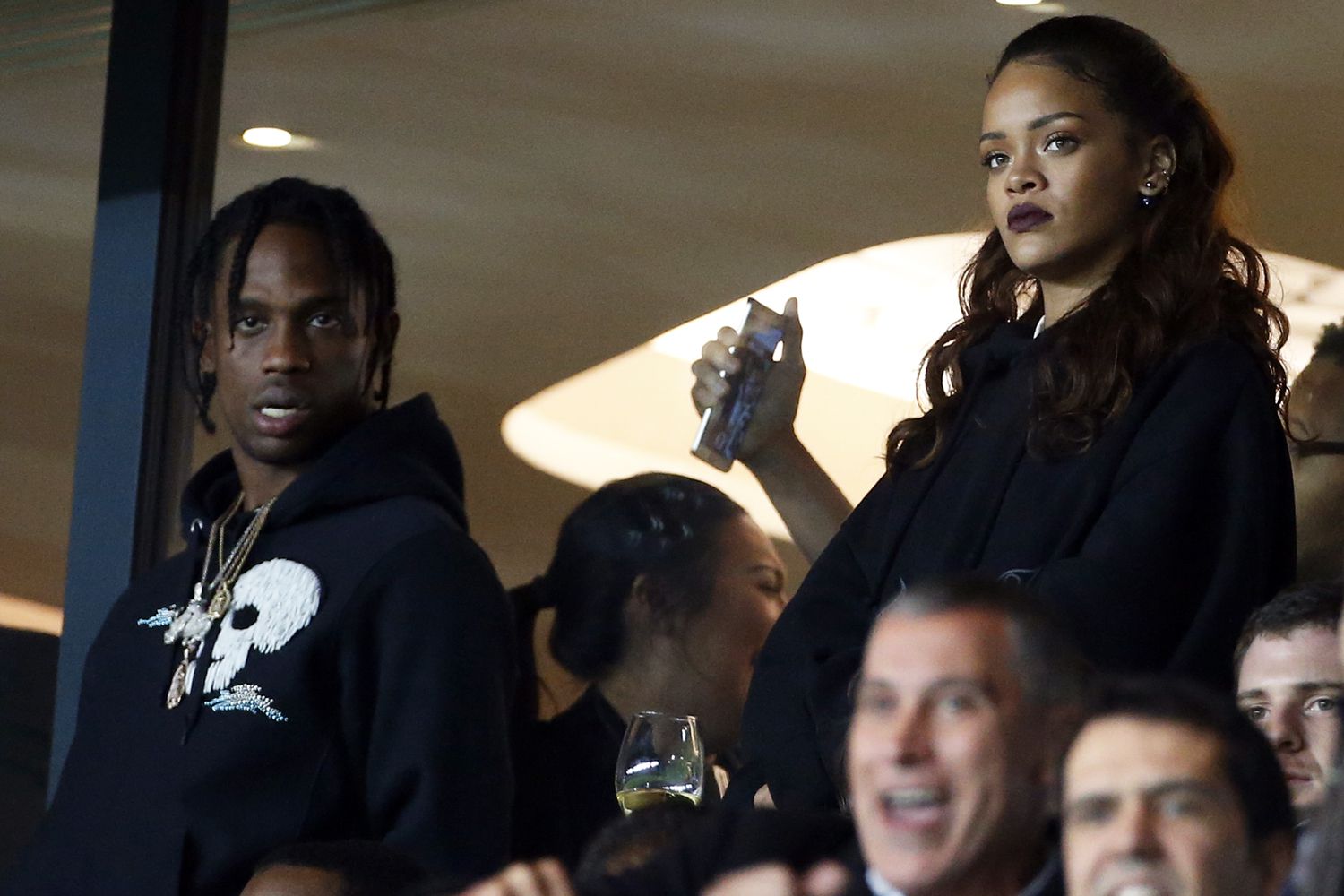 Rihanna and Travis Scott (left) attend the French Ligue 1 match between Paris Saint-Germain FC (PSG) and Olympique de Marseille at Parc des Princes stadium