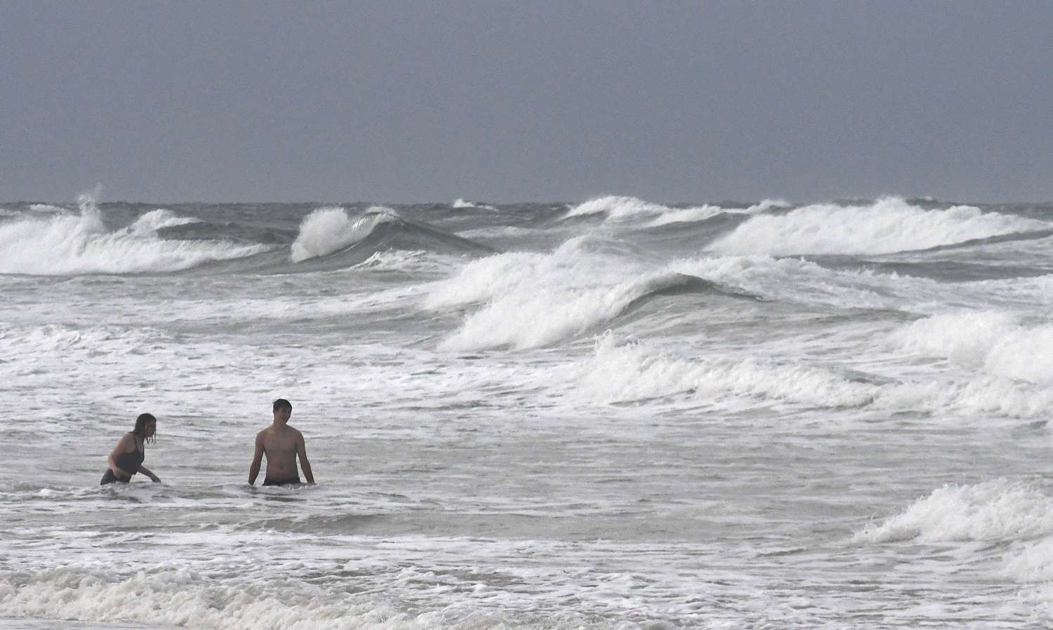 Swimmers enjoy heavy waves as Tropical Storm Isaias travels up the Atlantic coast on August 2, 2020 in Ponce Inlet, Florida