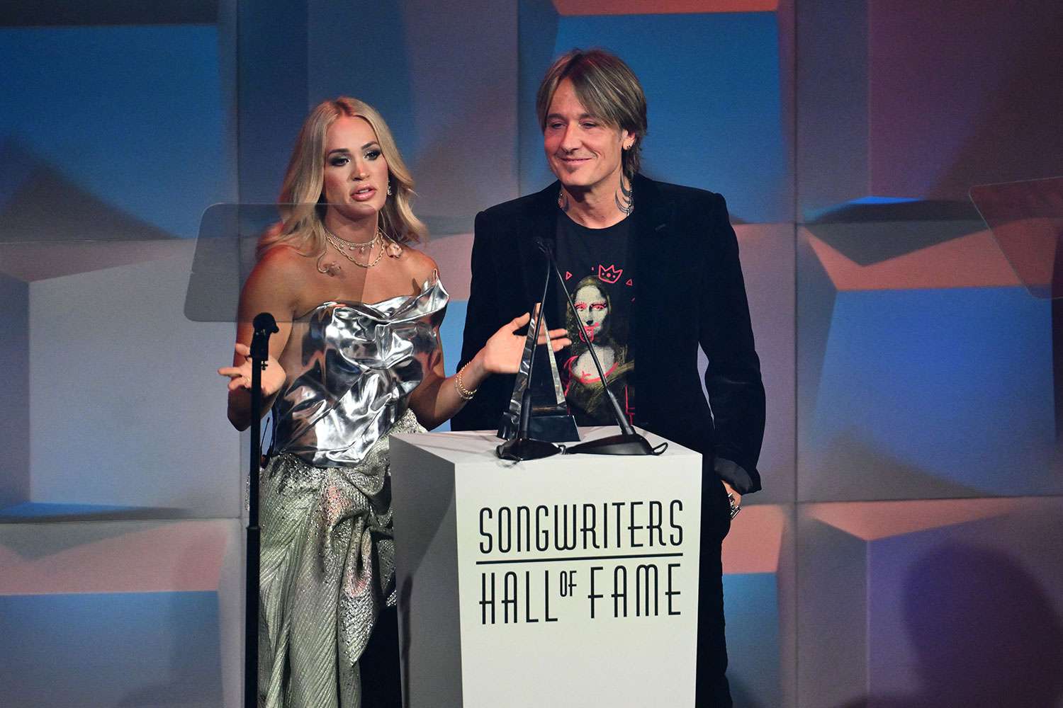 US singer-songwriter Carrie Underwood (L) and Australian-US musician Keith Urban speak onstage during the Songwriters Hall of Fame 2024 induction and awards gala at the New York Marriott Marquis Hotel in New York City on June 13, 2024.