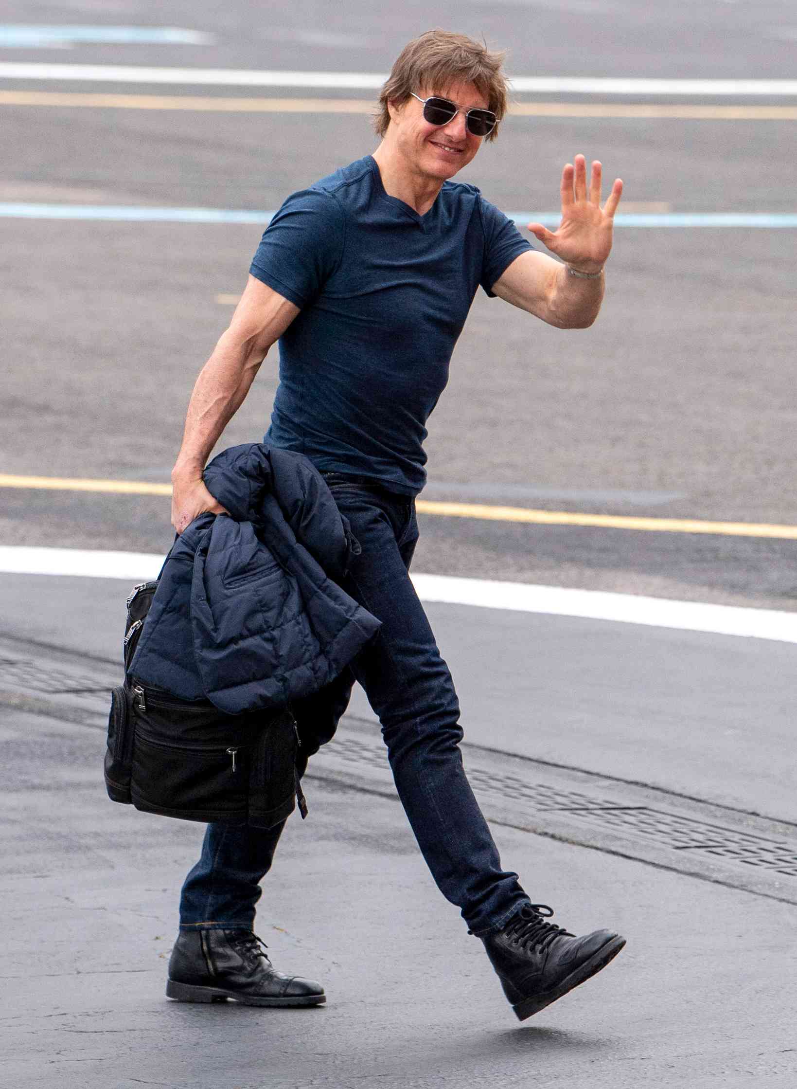 Tom Cruise shows off his biceps as he is seen arriving into Battersea heliport on his 62nd birthday, after working on the latest Mission Impossible movie at Longcross Studios on July 3, 2024.