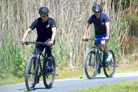 President Joe Biden (L) with his son Hunter Biden, rides his bike at Gordons Pond in Rehoboth Beach, Delaware