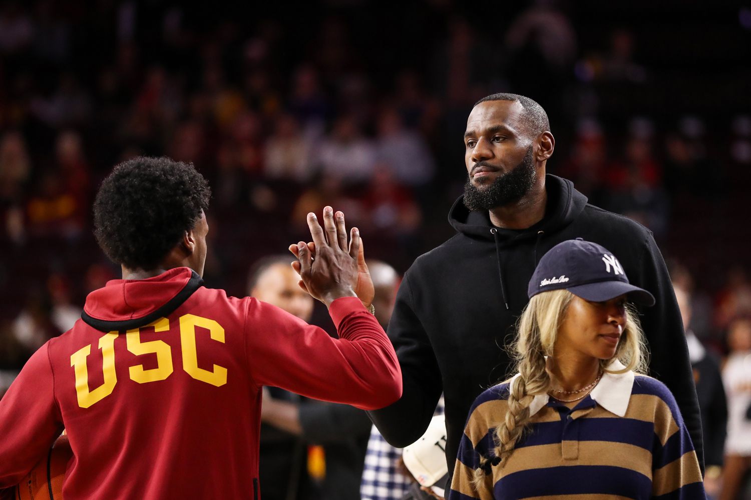 Bronny James #6 of the USC Trojans greets LeBron James of the Los Angeles Lakers before the game against the Stanford Cardinal at Galen Center on January 06, 2024 in Los Angeles, California