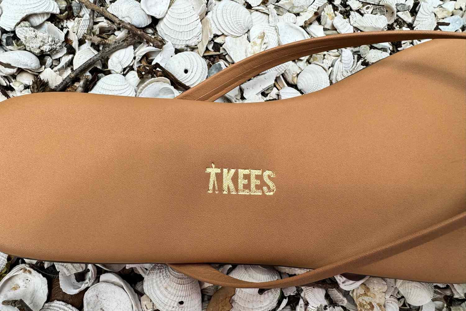 close-up of the logo on the Tkees Flip-Flop Sandal
