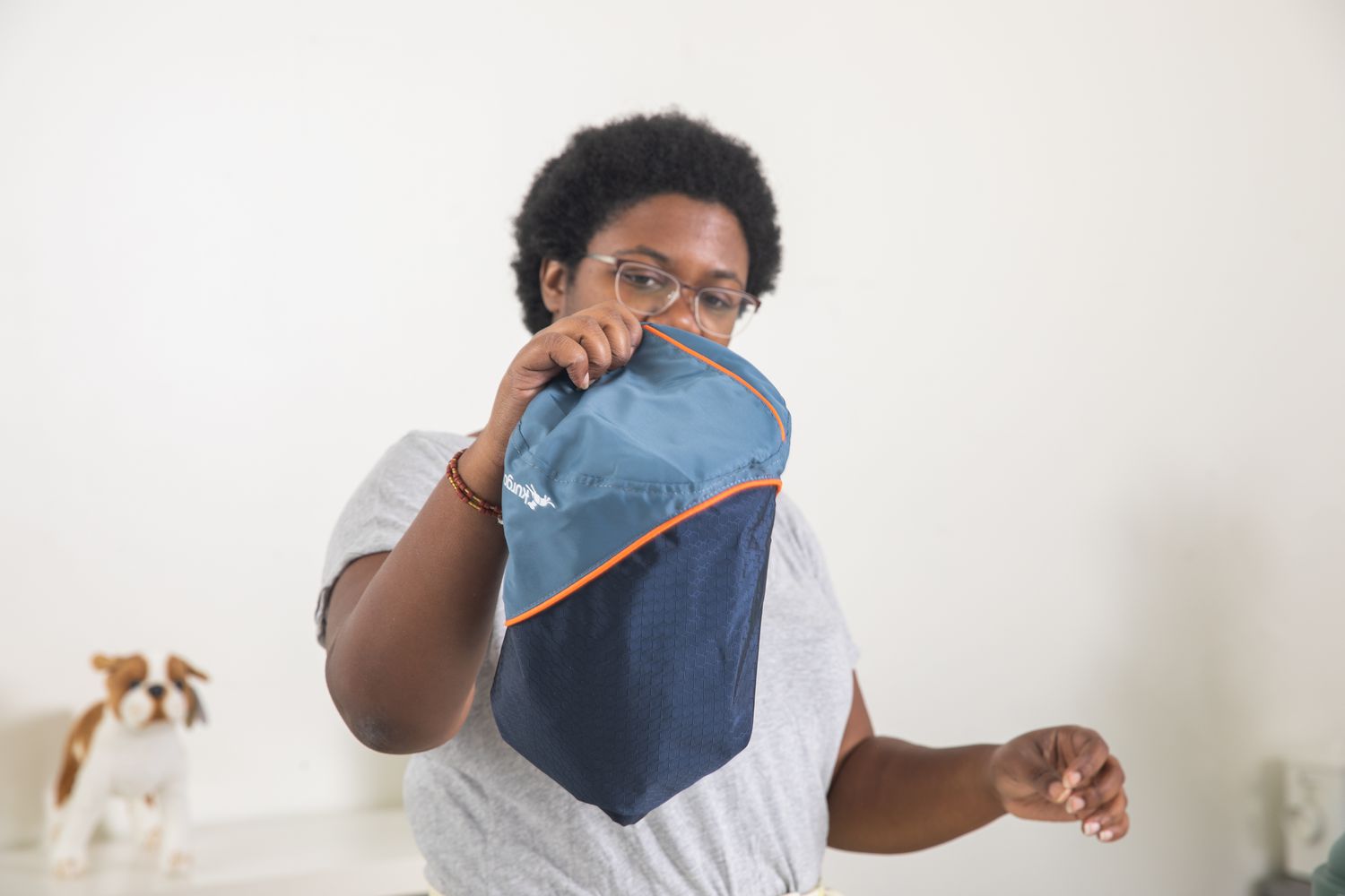 person holding up closed Kurgo Kibble Carrier