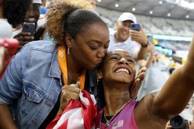 Sha'Carri Richardson of Team United States celebrates winning the Women's 100m Final with her mother Shay during day three of the World Athletics Championships Budapest 2023 at National Athletics Centre on August 21, 2023