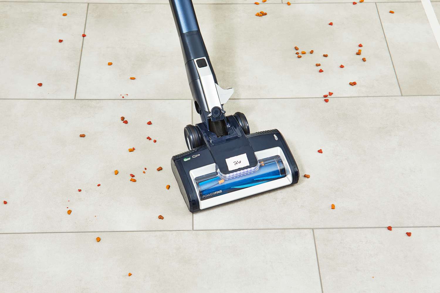 Shark Canister Pet Bagless Corded Vacuum used to clean spill on tile floor