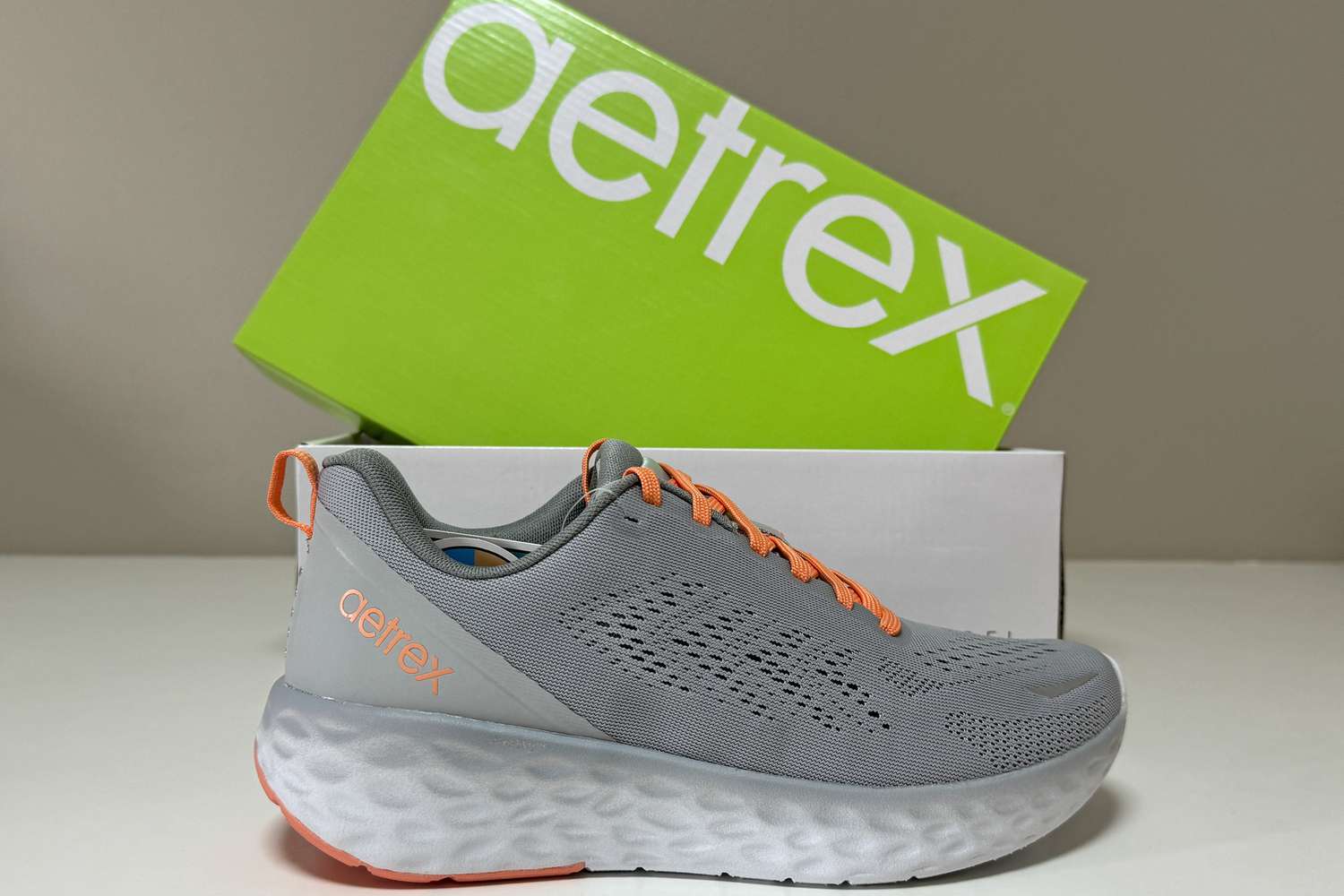 The Aetrex Danika Arch Support Sneaker in front of the brand's shoe box