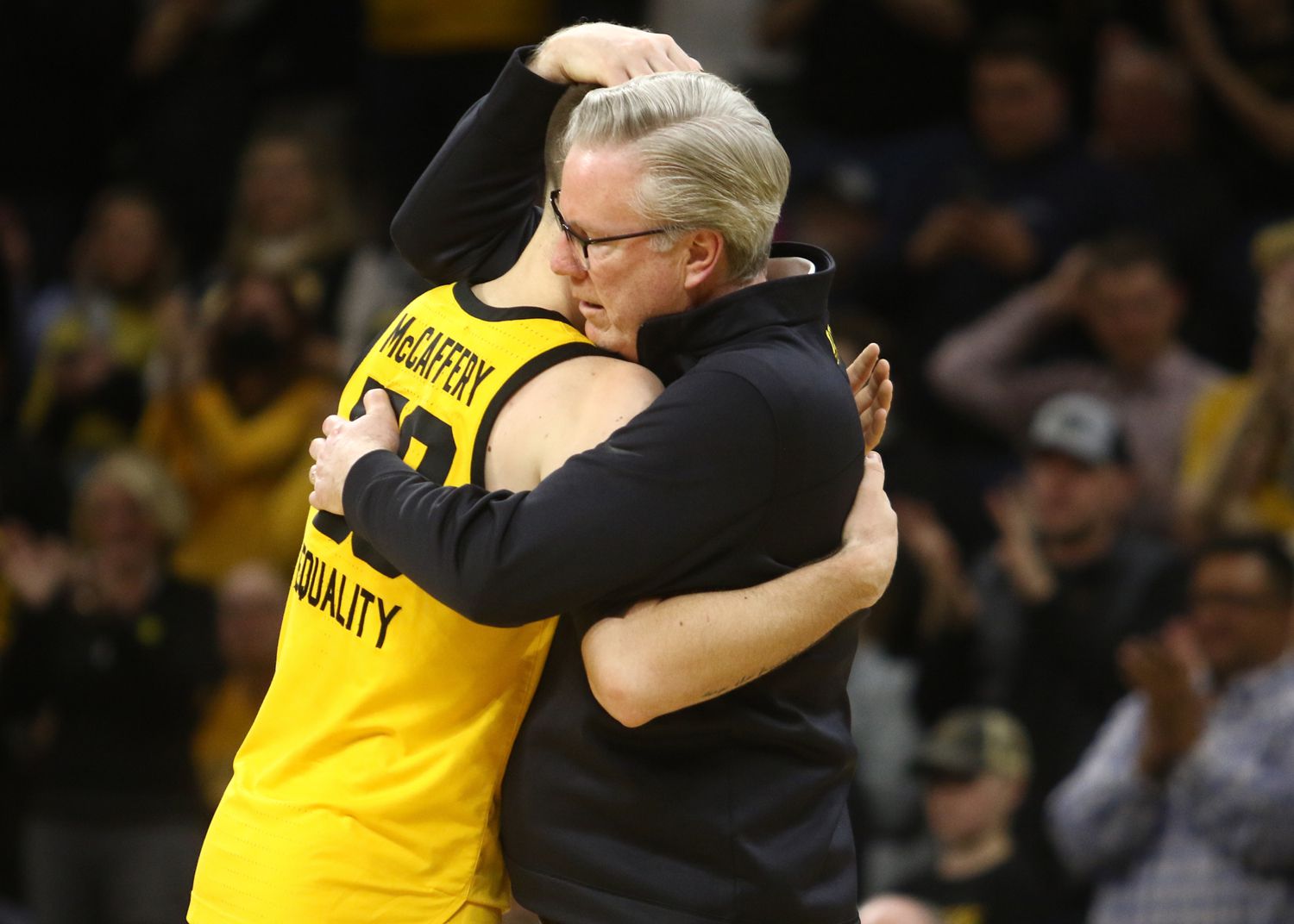 Guard Connor McCaffery #30 of the Iowa Hawkeyes hugs his father head coach Fran McCaffery after getting subbed out late in the second half of the match-up against the Northwestern Wildcats at Carver-Hawkeye Arena on February 28, 2022