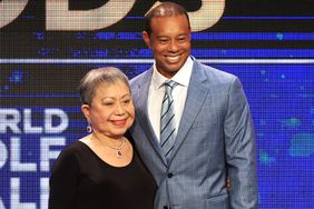 Tiger Woods and his mother Kultida Woods react as they pose for photos prior to his induction at the 2022 World Golf Hall of Fame Induction at the PGA TOUR Global Home on March 09, 2022 in Ponte Vedra Beach, Florida.