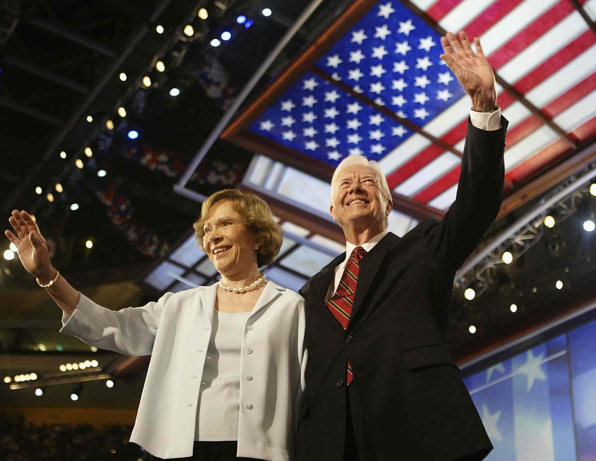 Former U.S. President Jimmy Carter and his wife Rosalynn wave to the audience during the Democratic National Convention at the FleetCenter July 26, 2004 in Boston, Massachusetts. Democratic presidential candidate U.S. Senator John Kerry (D-MA) is expected to accept his party's nomination later in the week