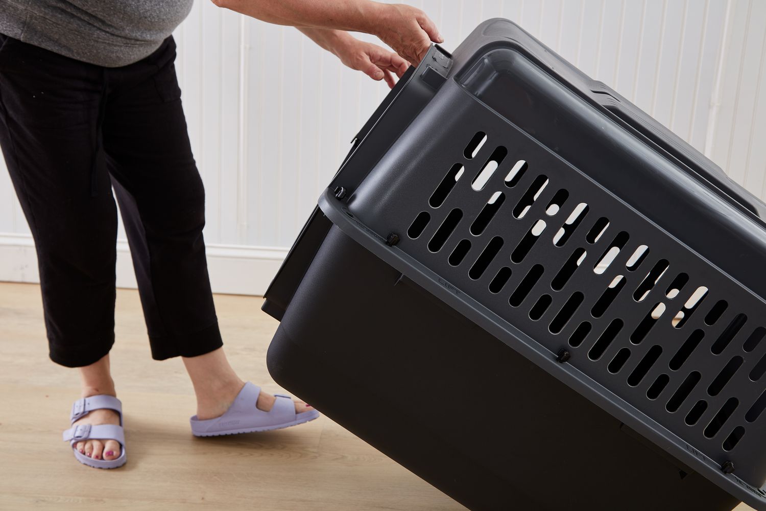 person slightly lifting the Petmate ASPEN PET Pet Porter Dog Kennel of the ground