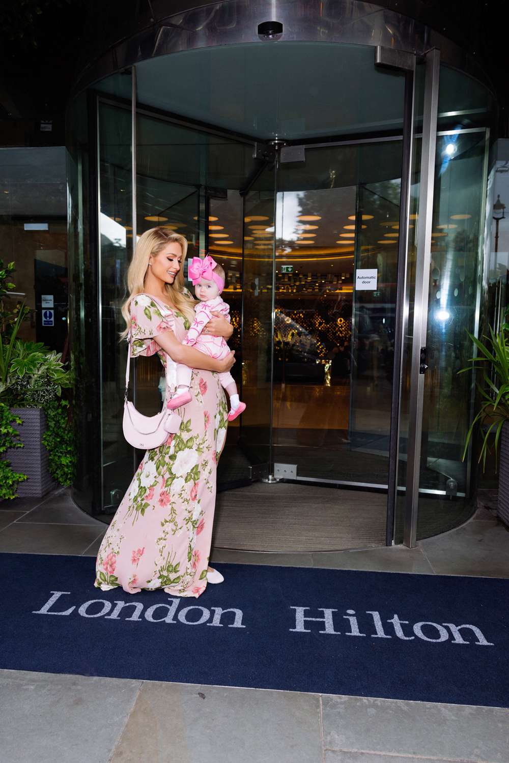 Paris Hilton Poses with Daughter London Outside the London Hilton