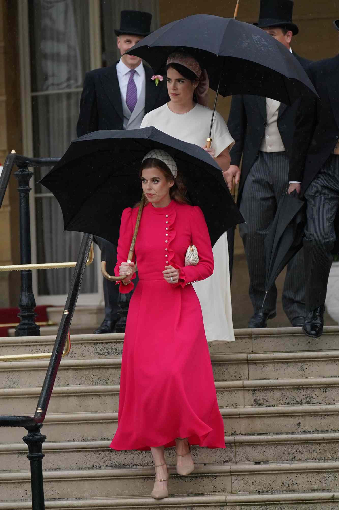 Princess Beatrice (front) and Princess Eugenie arrive for the Sovereign's Garden Party at Buckingham Palace on May 21, 2024 in London, England. 