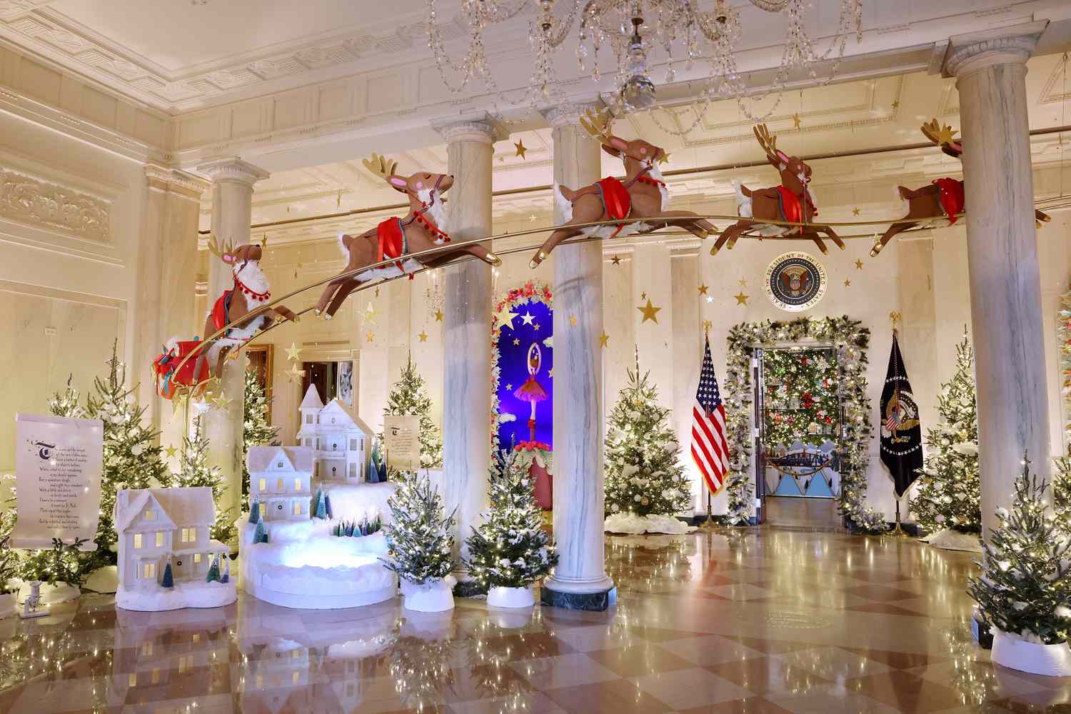 Santa Clause in his sleigh and a team of reindeer fly through the columns of the Entrance Hall during a media preview of the 2023 holiday decorations at the White House November 27, 2023