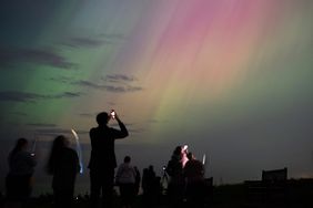 People visit St Mary's lighthouse in Whitley Bay to see the aurora borealis, commonly known as the northern lights, on May 10, 2024