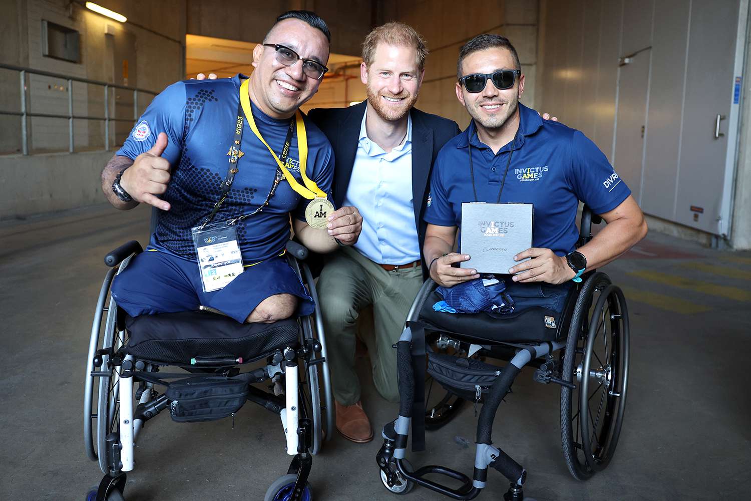 Prince Harry, Duke of Sussex meets competitors as he attends the track and field at the athletics track during day two of the Invictus Games