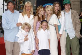 Mary-Kate Olsen and Ashley Olsen with dad David (left), step mom MacKenzie, Jake and Taylor (front), sister Lizzie and brother Trent