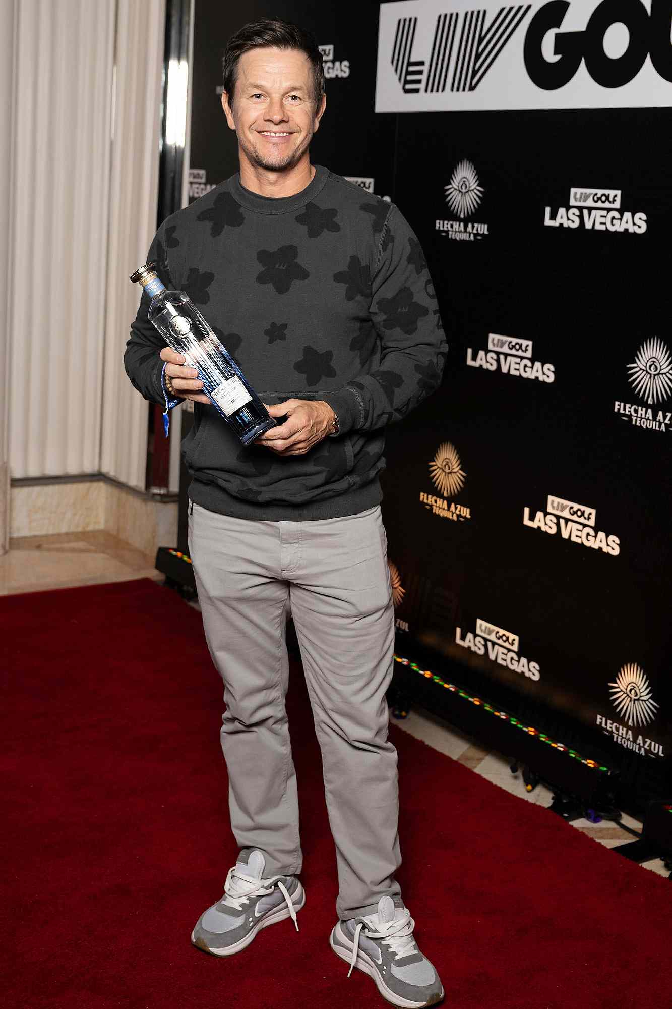 American actor and owner-partner at Flecha Azul, Mark Wahlberg poses for a photo with the Flecha Azul Tequila during the 2024 Official LIV Golf Las Vegas Party at the Wynn Las Vegas on Saturday, February 10, 2024 in Las Vegas, United States. 