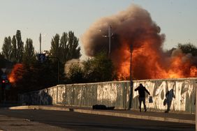 A man falls is seen on the ground after a blast following a drone attack in Kyiv on October 17, 2022, amid the Russian invasion of Ukraine.