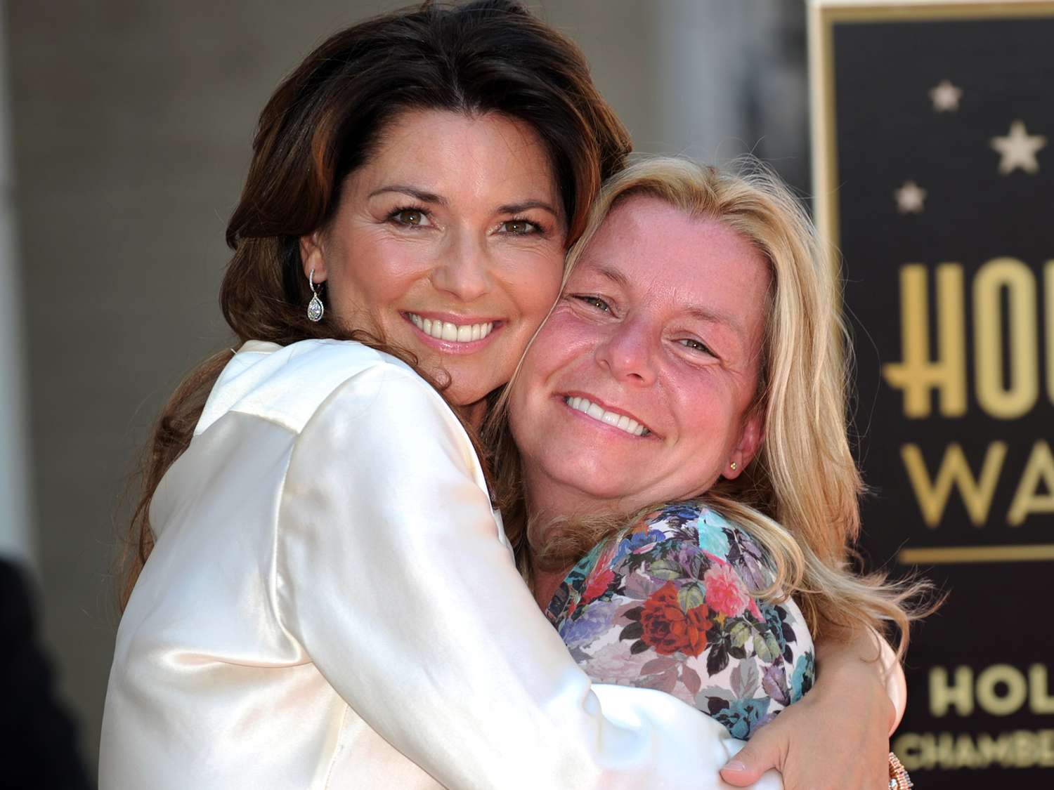 Shania Twain poses with her sister Carrie-Ann Edwards, after being honored by a Star on the Hollywood Walk of Fame in Hollywood, California on June 2, 2011