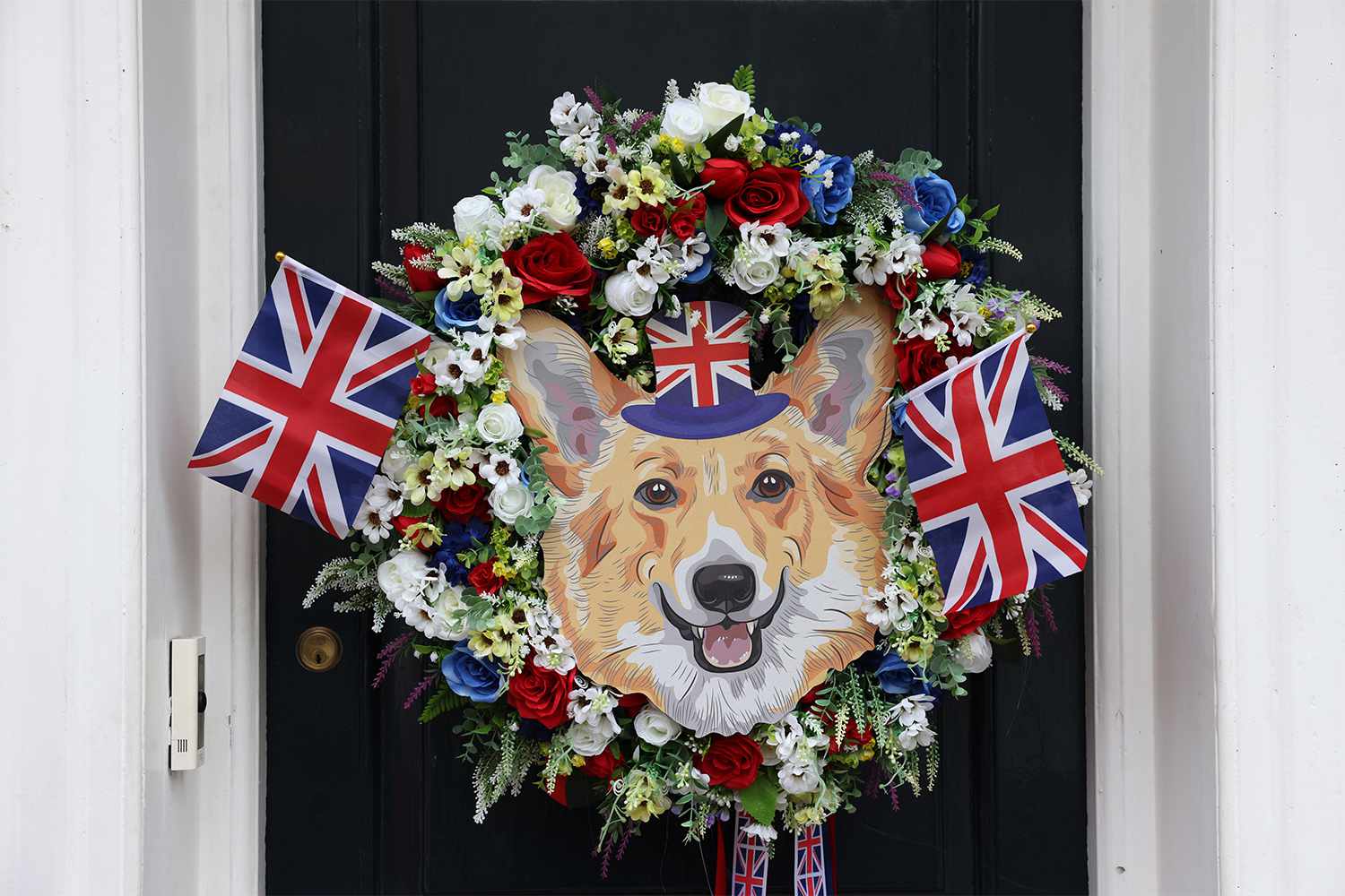 A wreath with British Union flags and a corgi image hangs on a door near Windsor castle during Platinum Jubilee celebrations in Windsor, UK, on Sunday, June 5, 2022. The Platinum Jubilee is a year of celebrations in the UK and Commonwealth countries to mark the 70th anniversary of the accession of Queen Elizabeth II on Feb. 6, 1952, which culminates with a four-day bank holiday weekend. Photographer: Hollie Adams/Bloomberg via Getty Images