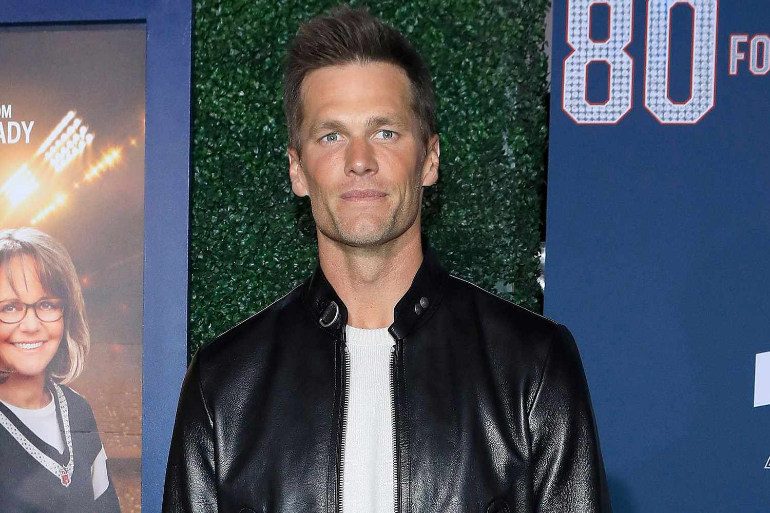 Tom Brady poses at the premiere of the '80 For Brady' movie