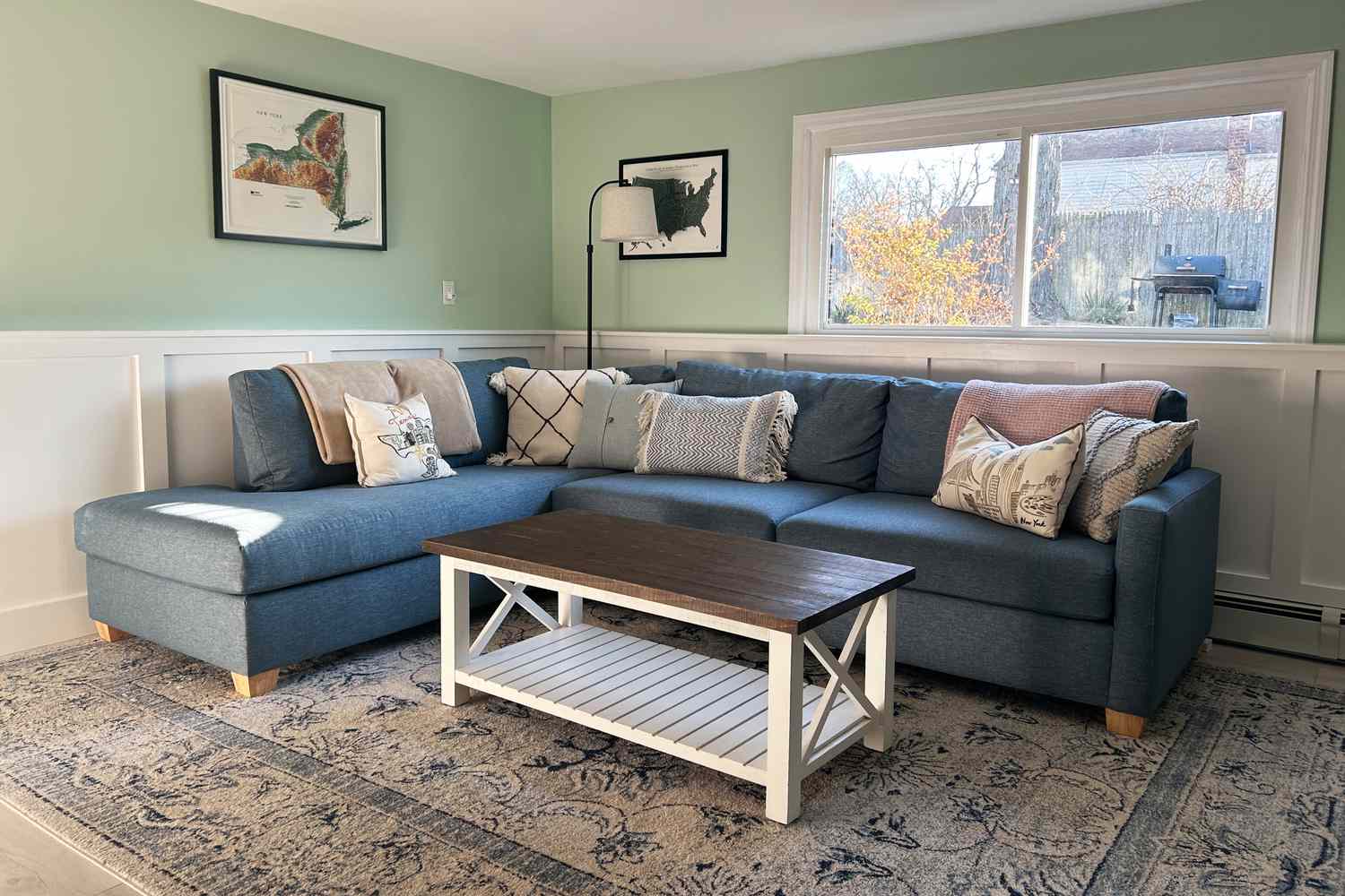 Apt2B Tuxedo 2-Piece Sleeper Sectional on a patterned rug with decorative pillows and a wooden coffee table