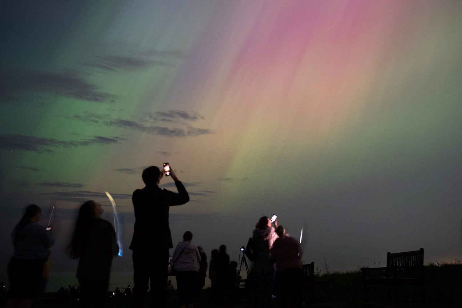 People visit St Mary's lighthouse in Whitley Bay to see the aurora borealis, commonly known as the northern lights, on May 10, 2024