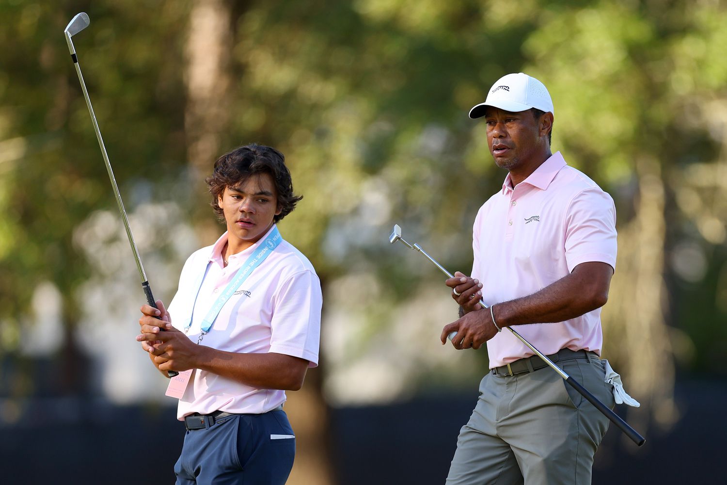 Tiger Woods of the United States and his son, Charlie Woods, look on from the second hole during a practice round prior to the U.S. Open at Pinehurst Resort on June 11, 2024 in Pinehurst, North Carolina.