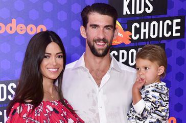 Nicole Phelps, swimmer Michael Phelps, and son Boomer Phelps attend Nickelodeon Kids' Choice Sports Awards 2018 at Barker Hangar on July 19, 2018 in Santa Monica, California. 