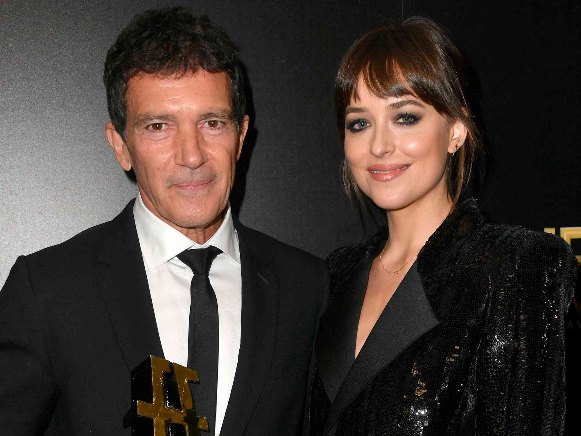 Antonio Banderas, winner of the Hollywood Actor Award, and Dakota Johnson pose in the press room during the 23rd Annual Hollywood Film Awards