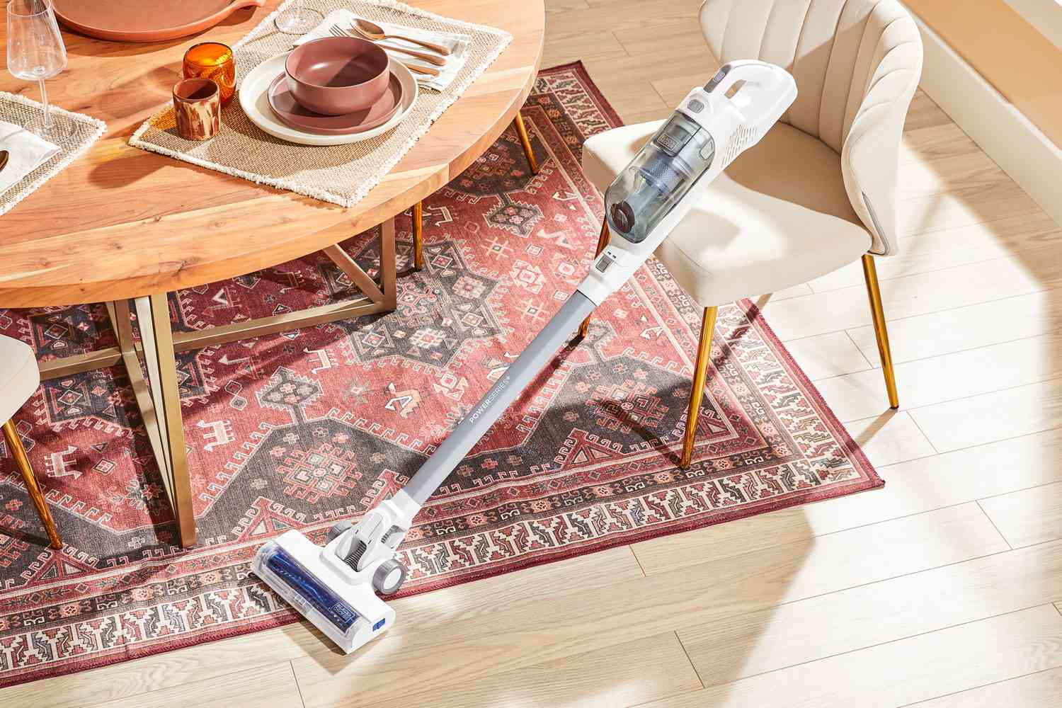 The Black + Decker Powerseries+ 16V MAX Cordless Stick Vacuum in a living room