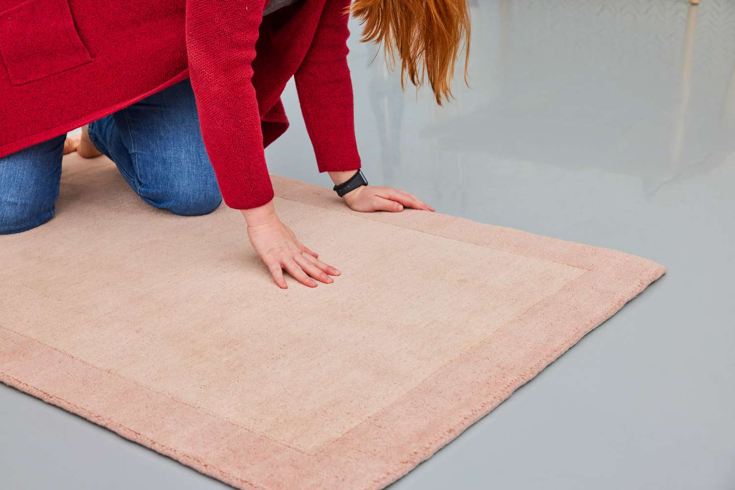 A person touches the GreenRow Rhodes Solid Rug