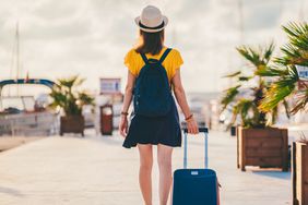 woman with suitcase trying to board cruise ship